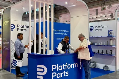 Platform Parts exhibition booth at GIS, with staff members assisting visitors and product displays showcasing aerial work platform components.